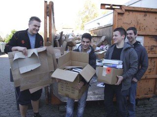 Die Schüler Jason Pazdzior, Süleyman Yurdakul, Pascal Wagner und Jonas Scheiter (v. l.) halfen mit, Papier in den Container zu packen. Foto: SMMP/Hofbauer